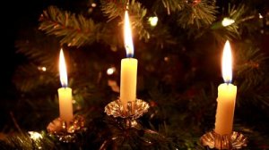 stock-footage-three-lit-candles-on-a-christmas-tree-and-at-the-end-being-blown-out-closeup-hd