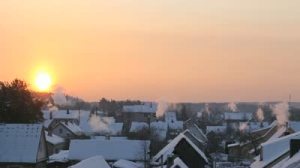stock-footage-little-town-s-morning-winter-view-the-main-accent-in-the-shot-is-rising-sun-and-rising-up-smoke
