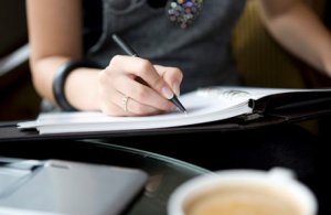 closeup-on-womans-hand-writing-in-planner460x300