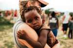 woman-on-gray-shirt-caring-african-child-with-gray-shirt-wallpaper-preview